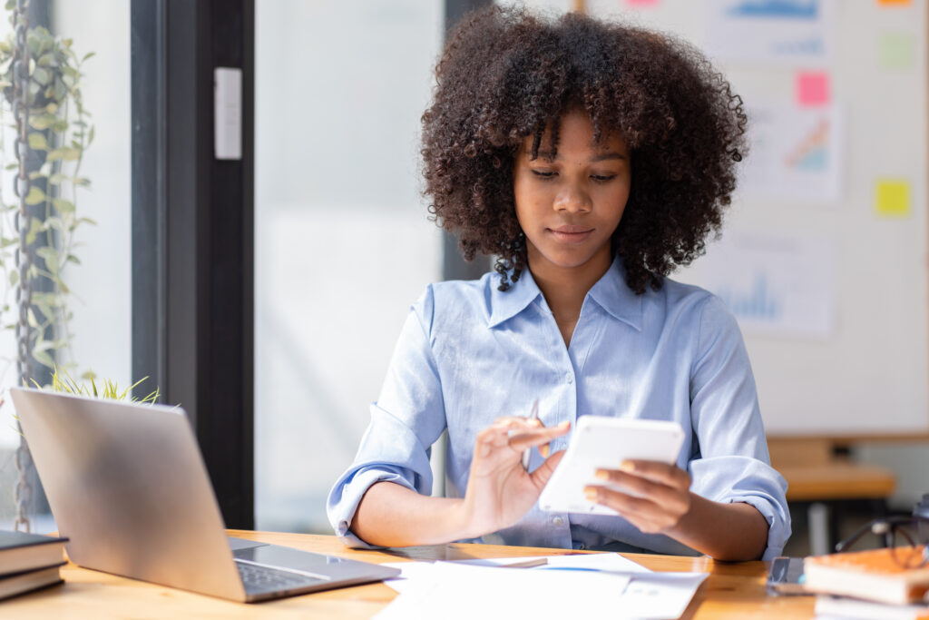 Accountant Young african businesswoman in afro hairstyle Using Calculator For documents Accounting