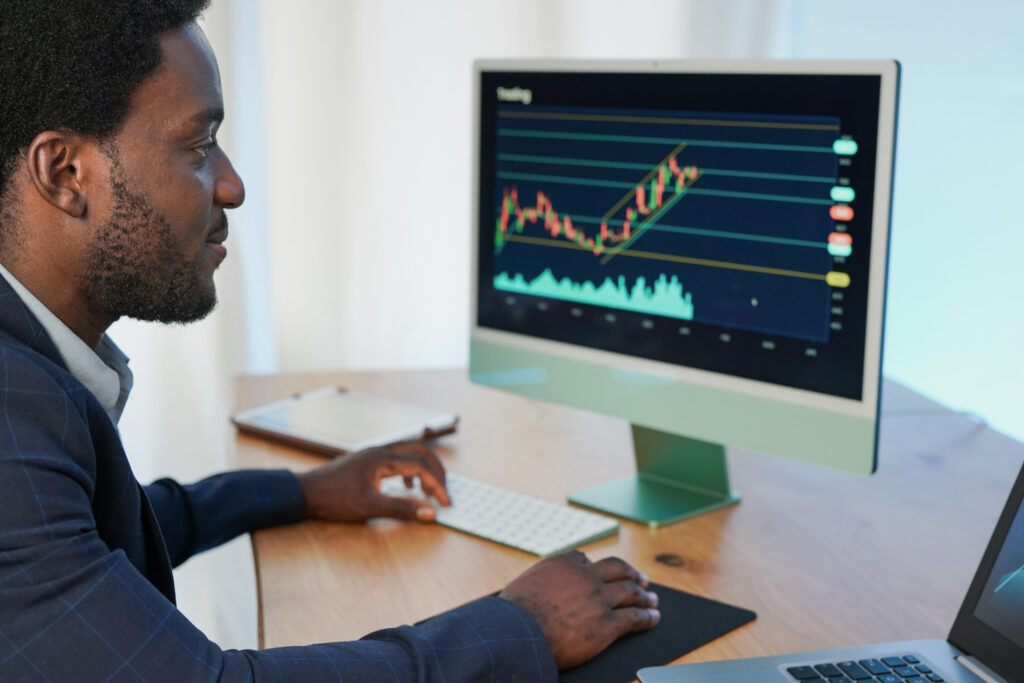 African trader working at home indoor and studying stock market